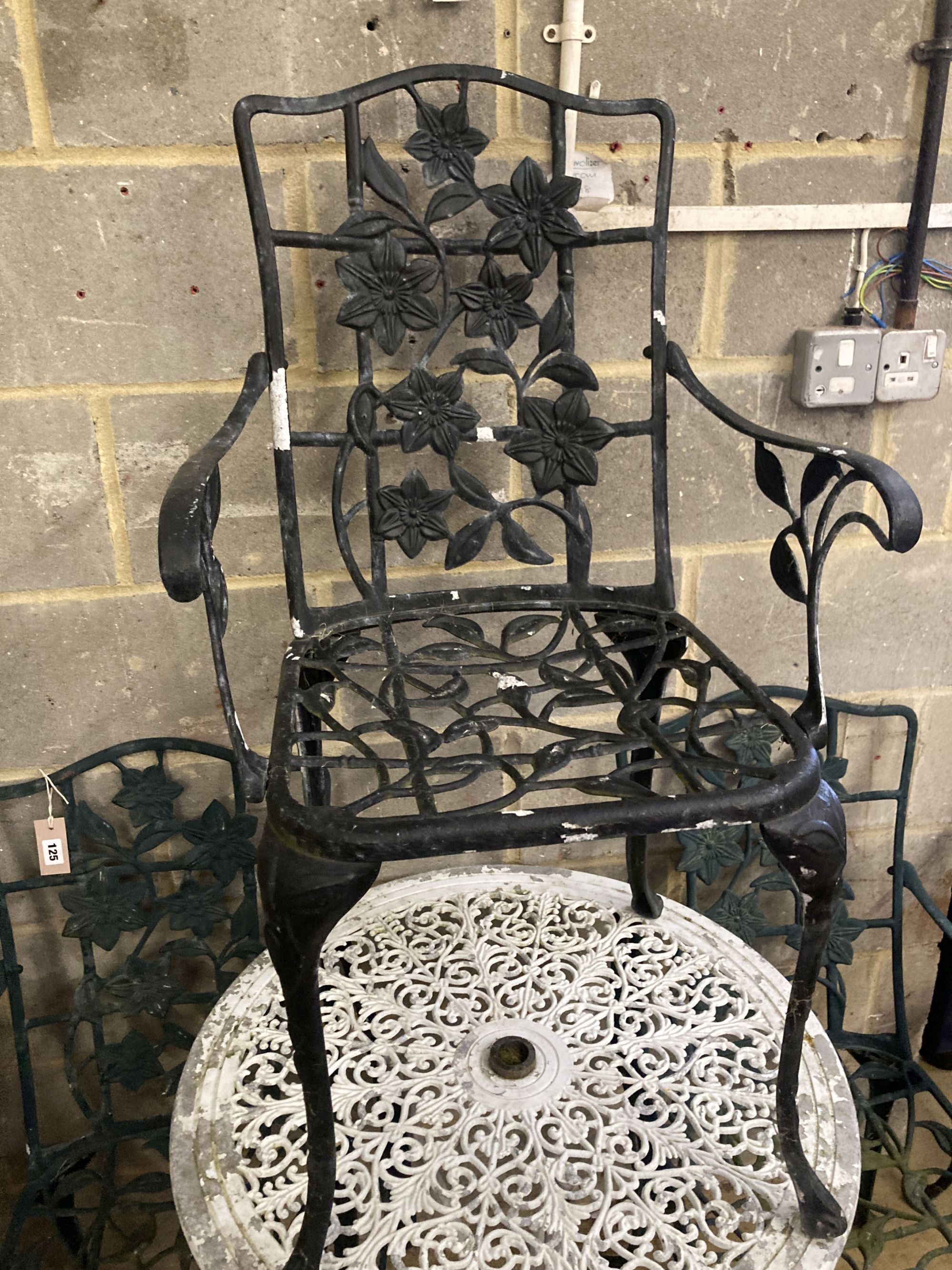 A Victorian style painted aluminium circular garden table, 69cm diameter together with a set of four garden elbow chairs